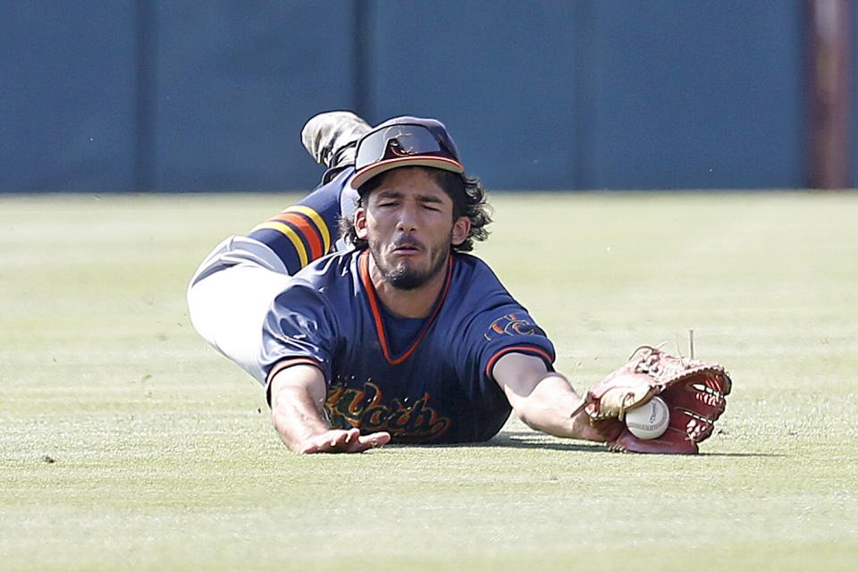 Chatsworth center fielder Ricky Arce attempts to catch a two run double hit by Roosevelt's Elijah Salazar.