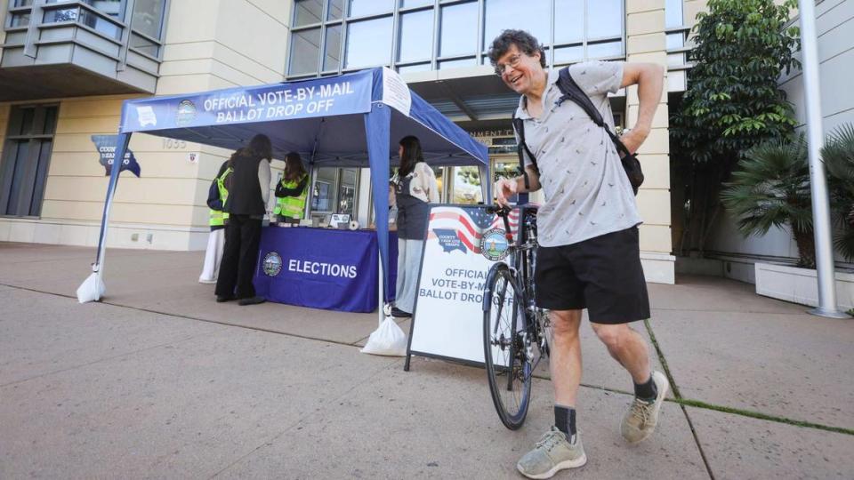 Pete Schwartz stops to drop off his ballot while bicycling on his way to the Cal Poly physics department. Ballots were being collected at the San Luis Obispo Clerk-Recorder’s office at the Katcho Achadjian Government Center during the Super Tuesday election on March 5, 2024. David Middlecamp/dmiddlecamp@thetribunenews.com