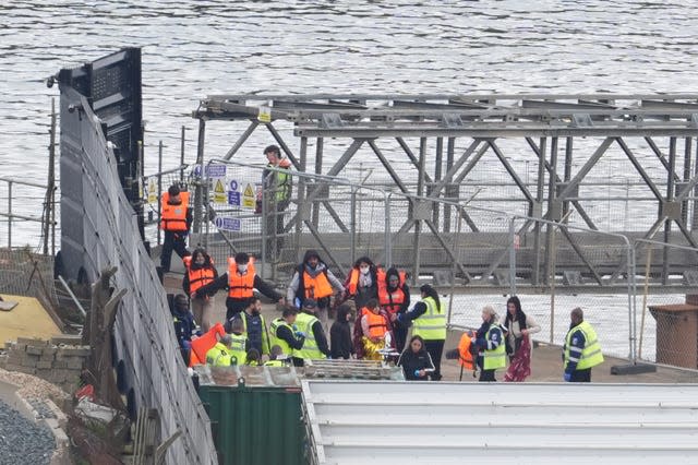 A group of people thought to be migrants are brought in to Dover