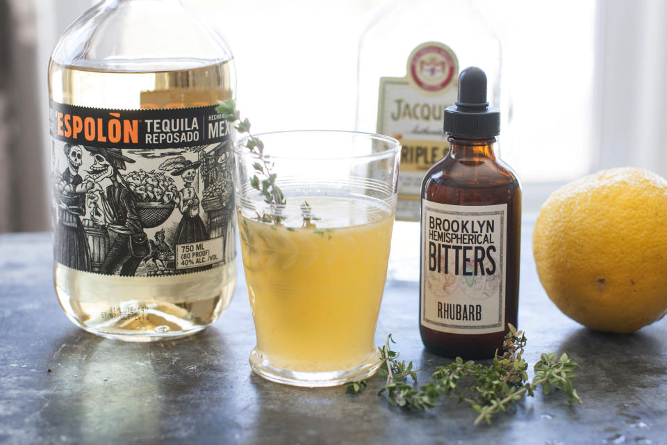 This Mar. 17, 2014 photo shows a Summer Rain, a drink made with rhubarb bitters, in Concord, N.H. (AP Photo/Matthew Mead)