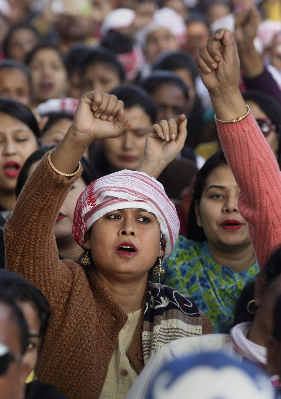 Indians shout slogans during a protest against the Citizenship Amendment Act in Nalbari, India, Friday, Dec. 20, 2019. Police banned public gatherings in parts of the Indian capital and other cities for a third day Friday and cut internet services to try to stop growing protests against a new citizenship law that have left more than 10 people dead and more than 4,000 others detained. (AP Photo/Anupam Nath)