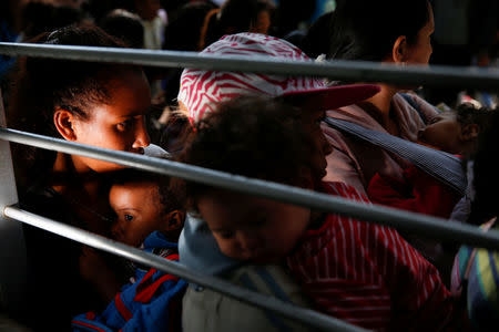 Women carrying babies queue on the street as they try to buy diapers outside a pharmacy in Caracas, Venezuela March 18, 2017. REUTERS/Carlos Garcia Rawlins