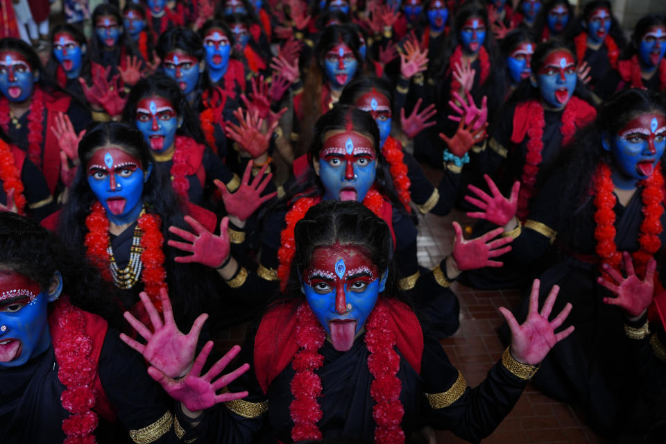 FILE - Students at a college with faces painted in blue pose for the media at an event held ahead of Hindu festival Janmashtami in Mumbai, India, Monday, Sept. 4, 2023. The nones in India come from an array of belief backgrounds, including Hindu, Muslim and Sikh. The surge of Hindu nationalism has shrunk the space for the nones over the last decade, activists say. (AP Photo/Rafiq Maqbool, File)