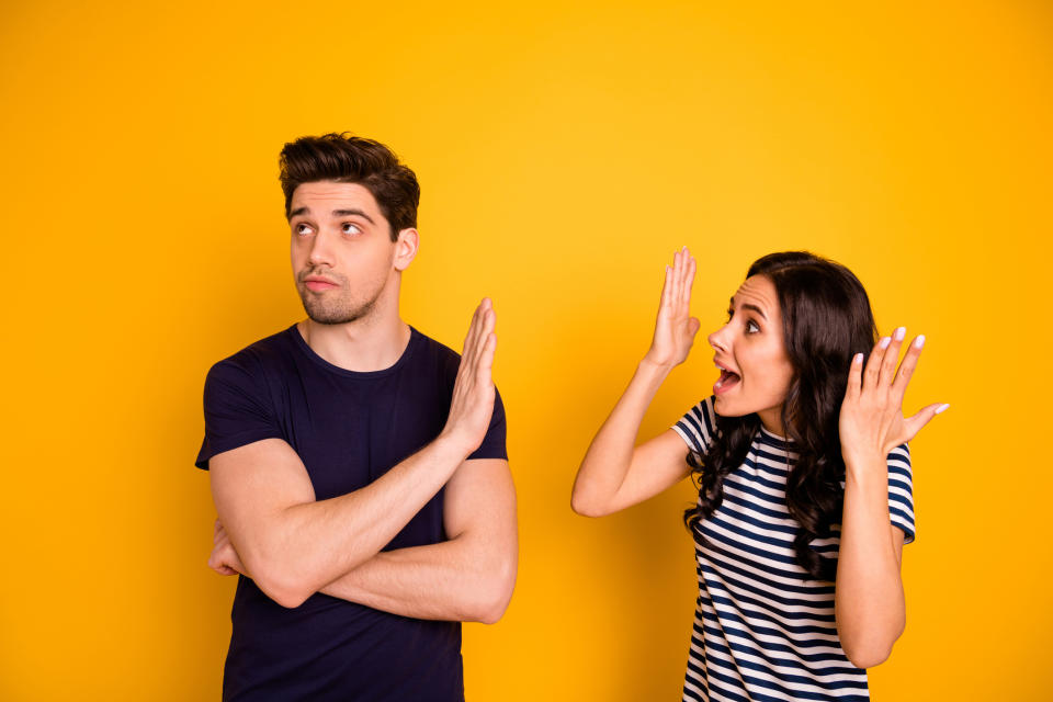 a man holding up his hand to a woman