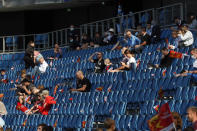 Spectators sit in the rows of Le Havre stadium prior to the friendly soccer match between Paris Saint Germain and Le Havre, in Le Havre, western France, Sunday, July 12, 2020. For the first time since the coronavirus shut down sports and chased away spectators, Neymar, Kylian Mbappe and other soccer stars are going to play again in front of fans. (AP Photo/Thibault Camus)