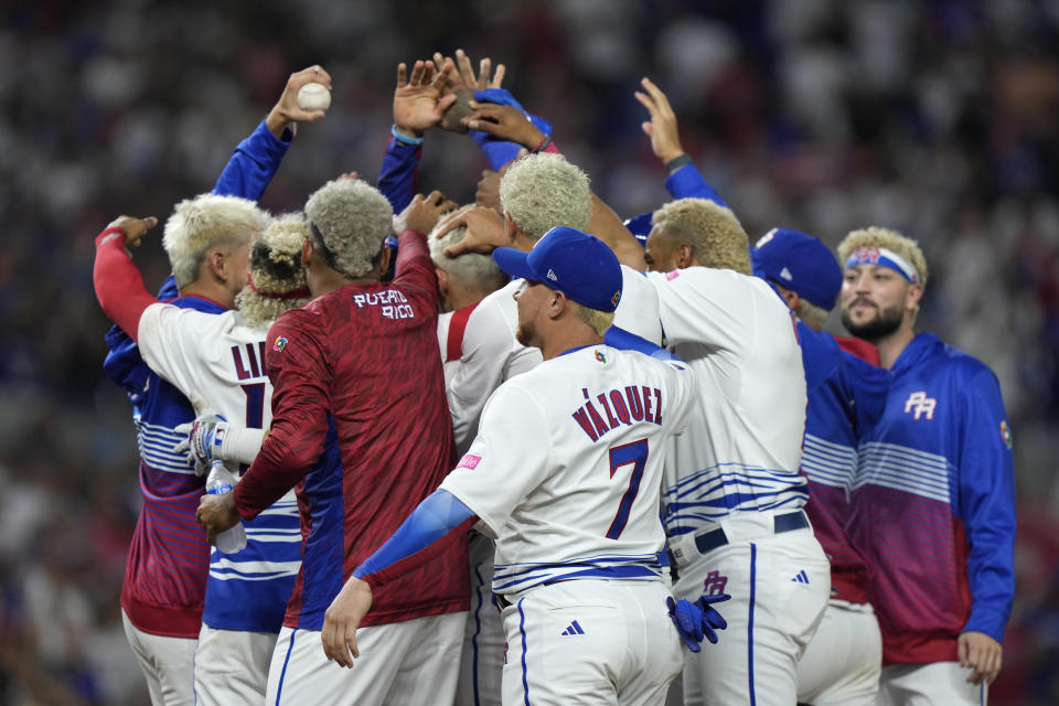 Puerto Rico players celebrate a 10-0 win over Israel with an 8th inning run-rule walk off and a combined perfect game during a World Baseball Classic game, Monday, March 13, 2023, in Miami. (AP Photo/Wilfredo Lee)