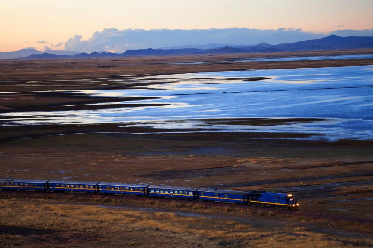 Train from Cusco to Puno travelling alongside Lake Titicaca during sunset