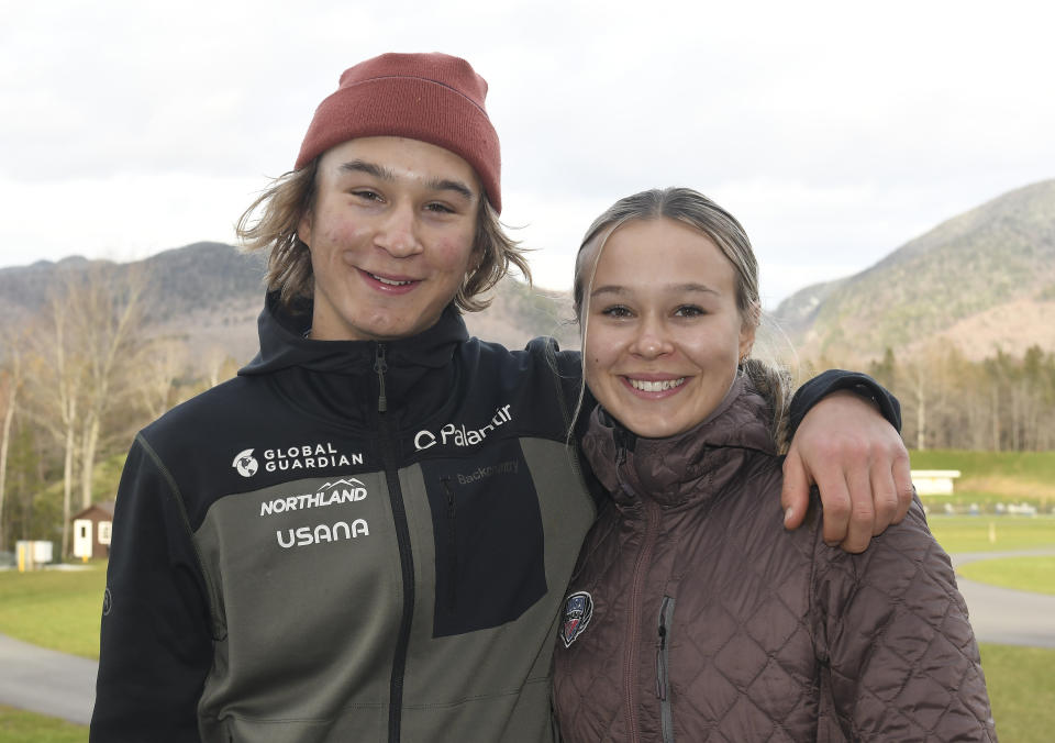 Niklas, left, and his sister Annika Malacinski pose at Mount Van Hoevenberg Olympic Sports Complex in Lake Placid, N.Y., Thursday, Nov. 4, 2021, The Americans, who have dual citizenship as Finns, dream of being Olympians in Nordic combined. Even before the U.S. teams were set for Beijing Games, though, 20-year-old Annika knew she had no shot at competing in China because she is a woman. (AP Photo/Hans Pennink)