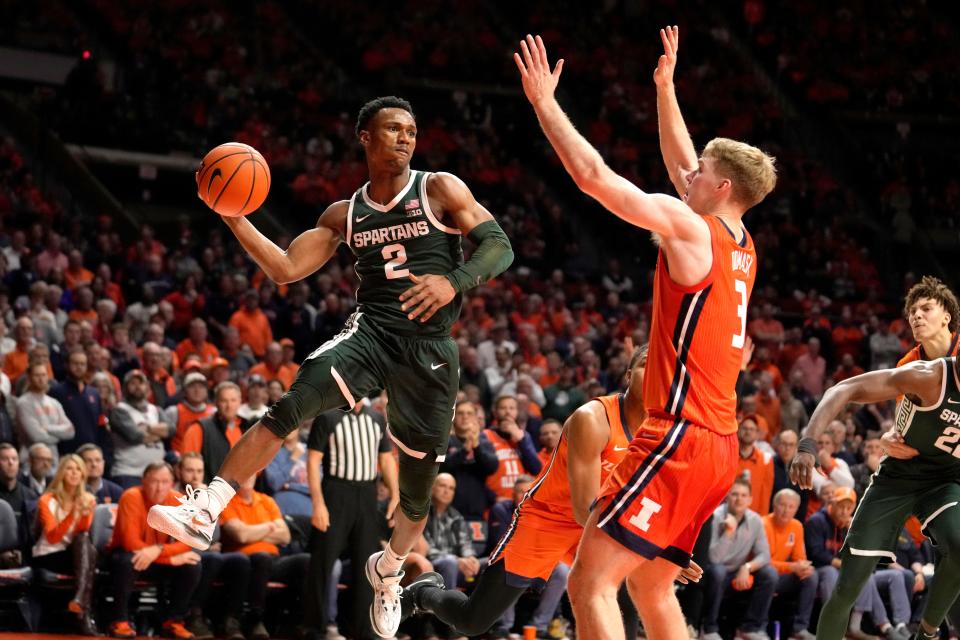 Michigan State's Tyson Walker (2) looks to pass the ball as Illinois' Marcus Domask defends defends during the second half of an NCAA college basketball game Thursday, Jan. 11, 2024, in Champaign, Ill. (AP Photo/Charles Rex Arbogast)