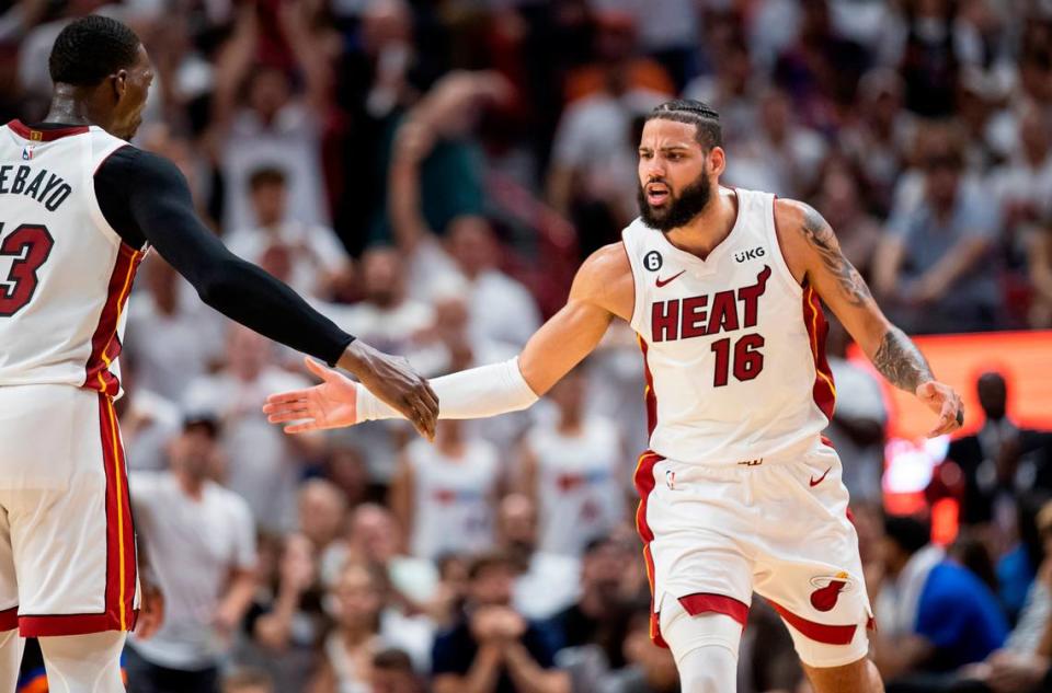 Miami Heat forward Caleb Martin (16) and center Bam Adebayo (13) celebrate after scoring against the New York Knicks in the fourth quarter of Game 4 of the NBA Eastern Conference Semifinals at the Kaseya Center in Miami on Monday, May 8, 2023.