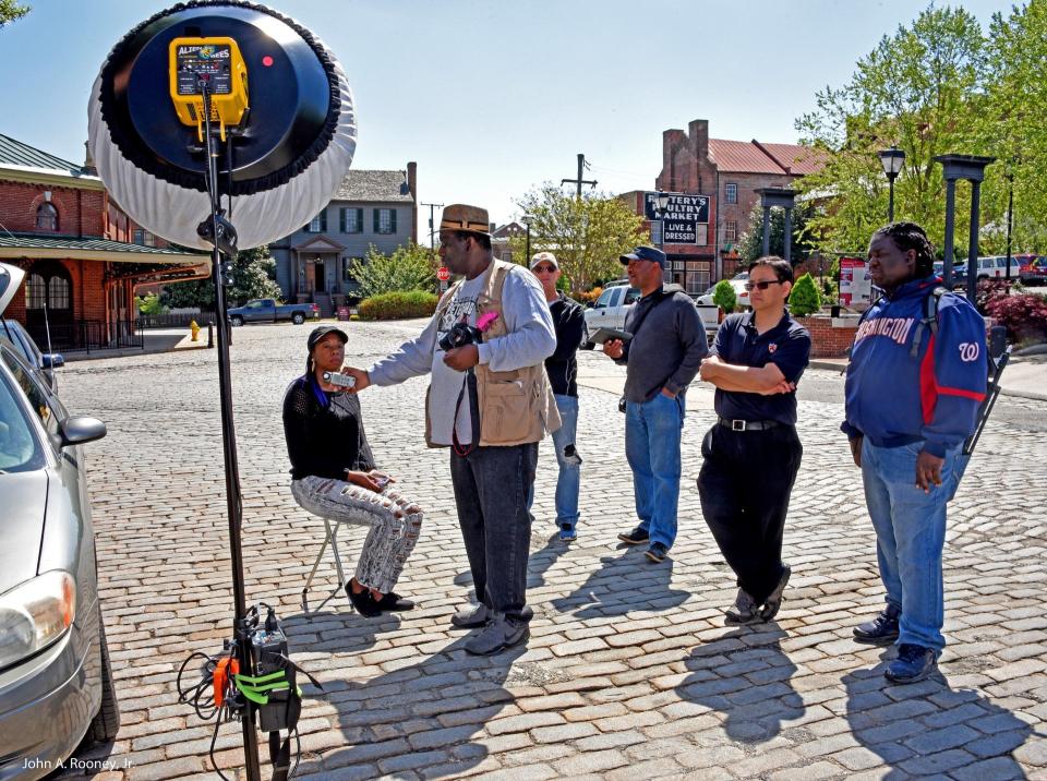 Second from the left, Gary D. Jones conducts a Daylight Flash Photography class in conjunction with the Cockade City Camera Club in 2015 in Old Towne Petersburg, Va.