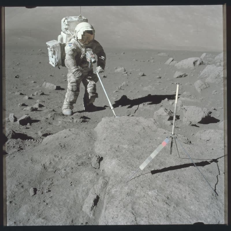 FILE PHOTO: Scientist-astronaut Harrison Schmitt, Apollo 17 lunar module pilot, uses an adjustable sampling scoop to retrieve lunar samples during the second Apollo 17 extravehicular activity in this NASA handout photo