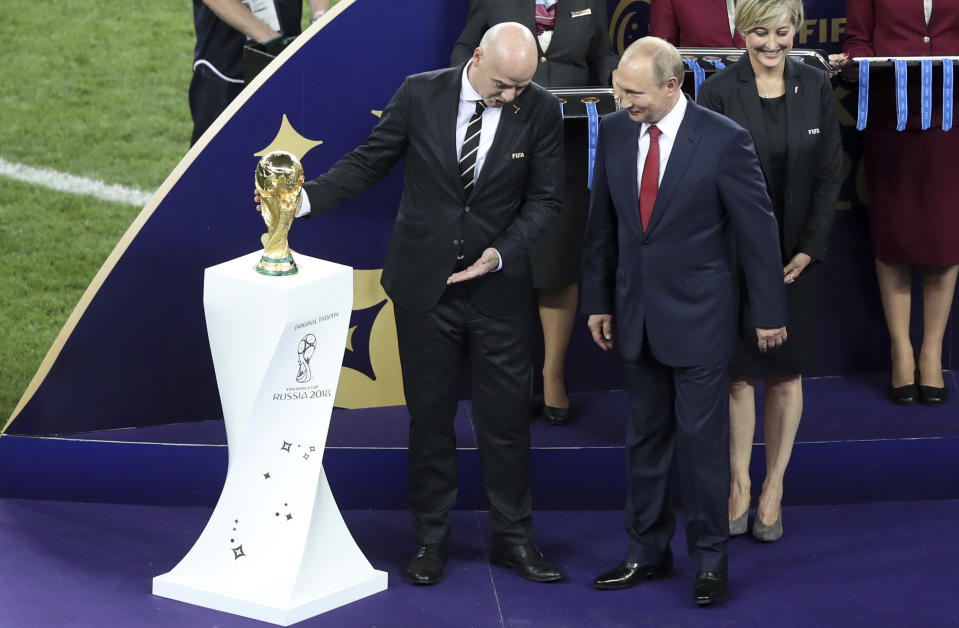 FIFA President Gianni Infantino, left, gestures while talking to Russian President Vladimir Putin next to the trophy at the end of the final match between France and Croatia at the 2018 soccer World Cup in the Luzhniki Stadium in Moscow, Russia, Sunday, July 15, 2018. (AP Photo/Thanassis Stavrakis)