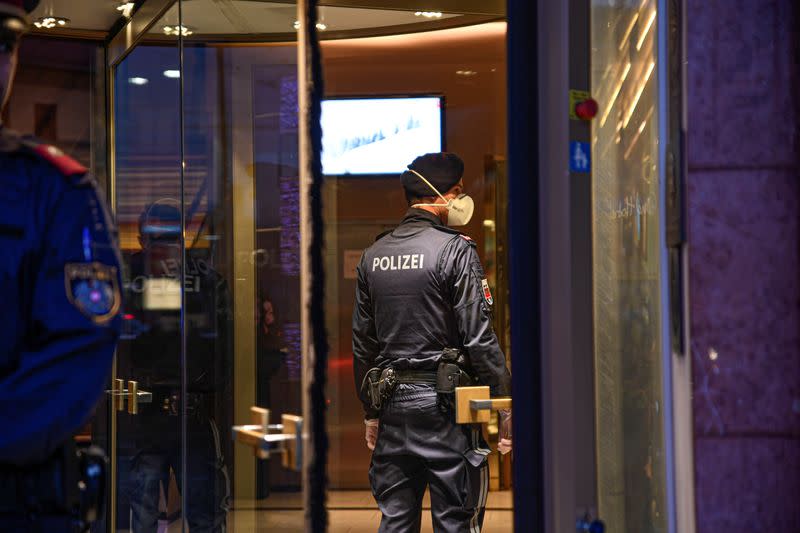 A policeman wears a respirator mask as he enters the Grand Hotel Europa in Innsbruck