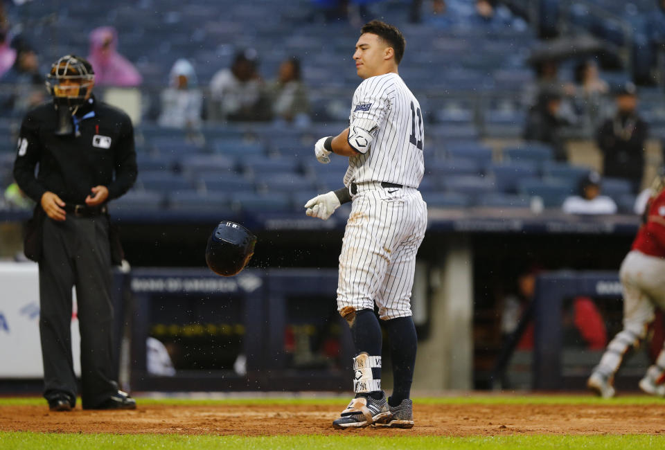New York Yankees' Anthony Volpe, center, tosses his helmet after striking out with the bases loaded to end the eighth inning during a baseball game against the Arizona Diamondbacks, Sunday, Sept. 24, 2023, in New York. (AP Photo/John Munson)