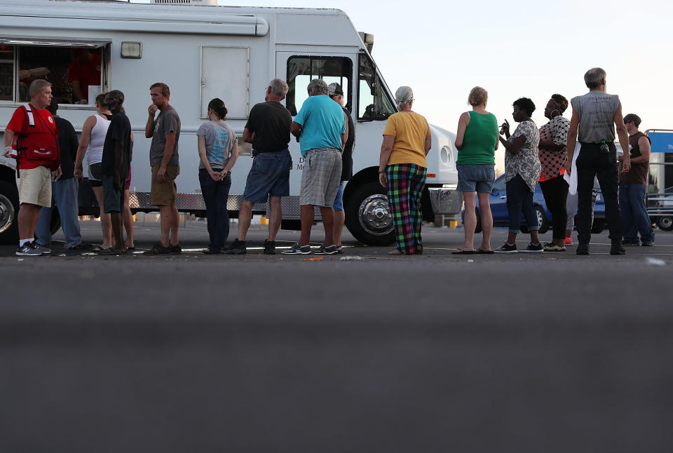 People stand in line to receive food from the Salvation Army emergency disaster services food distribution operation for people trying to recover in Panama City.&nbsp;