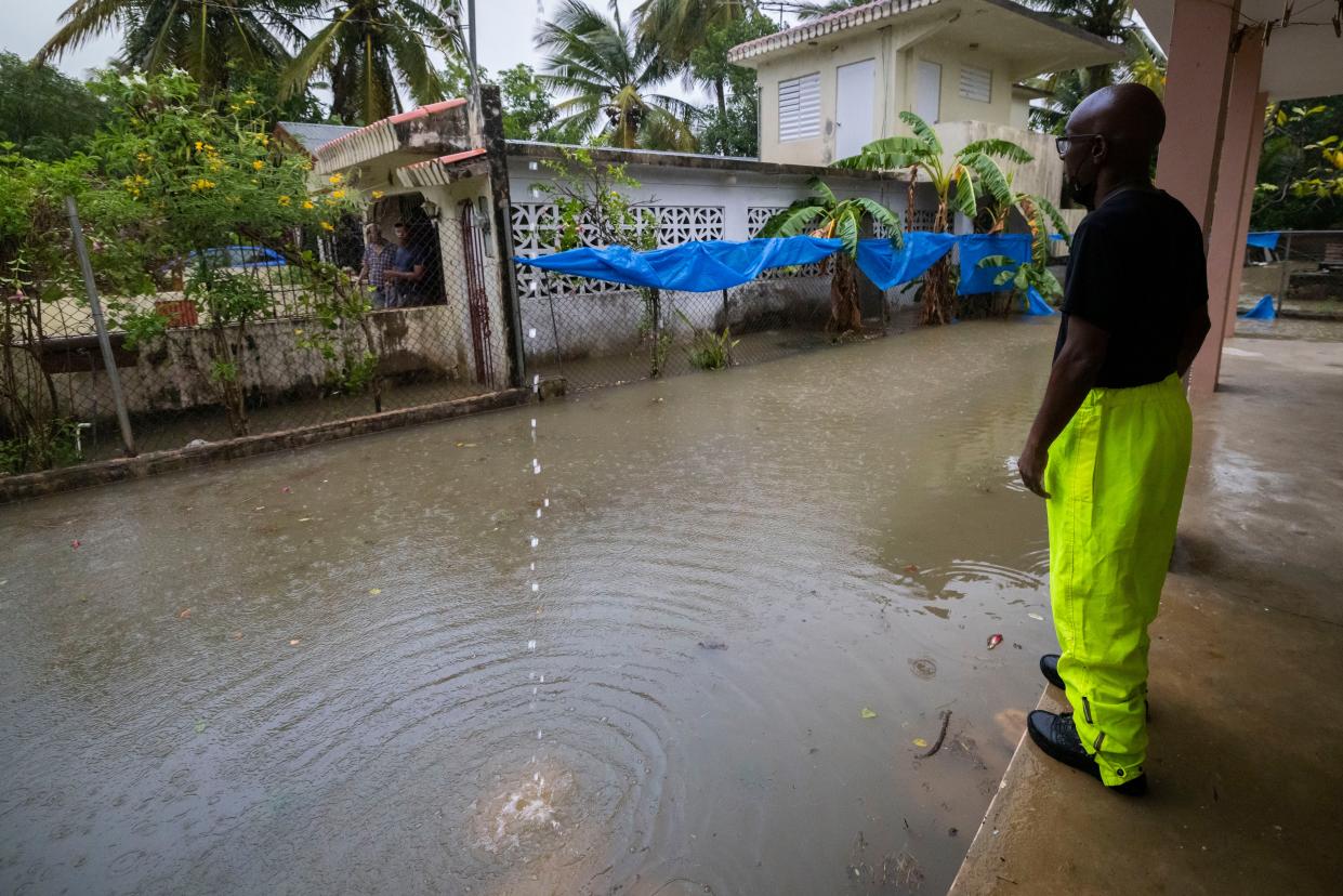 A worker of the Loiza municipality calls on residents to evacuate due to imminent flooding due to the rains of Hurricane Fiona, in Loiza, Puerto Rico, Sunday, September 18, 2022.