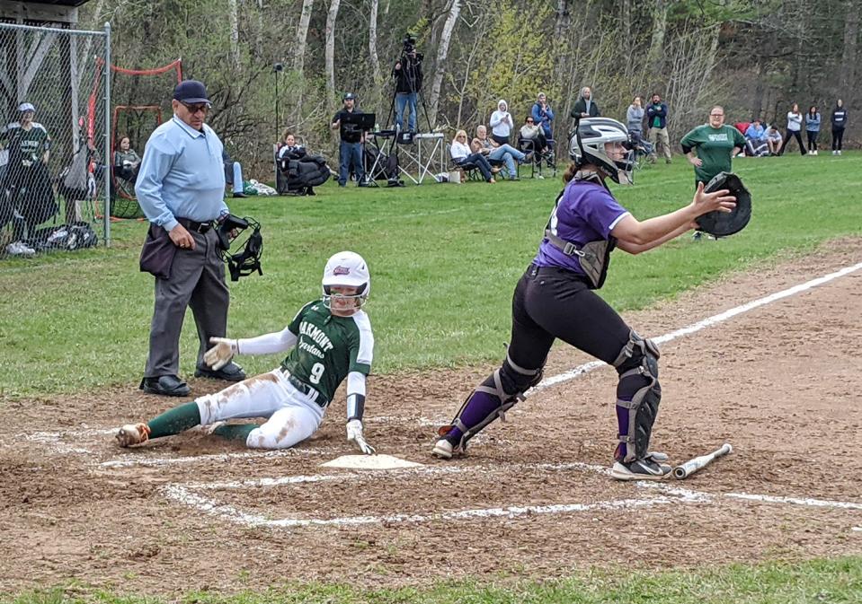 Oakmont's Olivia Souers (9) slides into home with a run for the Spartans while scoring on an RBI groundout by Gianna Gerbick during Wednesday's game against Monty Tech in Ashburnham.