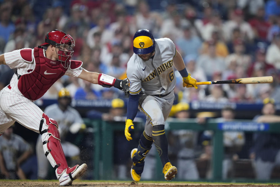 Philadelphia Phillies catcher J.T. Realmuto, left, tags out Milwaukee Brewers' Owen Miller on a dropped third strike during the ninth inning of a baseball game, Tuesday, July 18, 2023, in Philadelphia. (AP Photo/Matt Slocum)