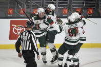 Minnesota Wild defenseman Mathew Dumba (24) congratulates defenseman Ryan Suter, left, on a game-tying goal during the third period of the team's NHL hockey game against the Los Angeles Kings in Los Angeles, Saturday, Jan. 16, 2021. (AP Photo/Kelvin Kuo)