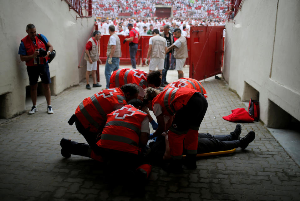 An injured reveller is helped by medical staff during the first running of the bulls at the San Fermin festival in Pamplona, Spain, July 7, 2019. (Photo: Jon Nazca/Reuters)