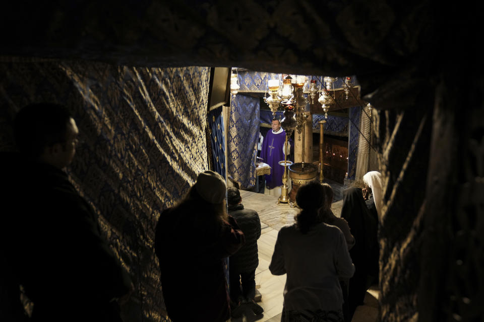 People visit the Grotto under the Church of the Nativity, traditionally believed to be the birthplace of Jesus, on Christmas Eve, in the West Bank city of Bethlehem, Sunday, Dec. 24, 2023. Bethlehem is having a subdued Christmas after officials in Jesus' traditional birthplace decided to forgo celebrations due to the Israel-Hamas war. (AP Photo/Mahmoud Illean)