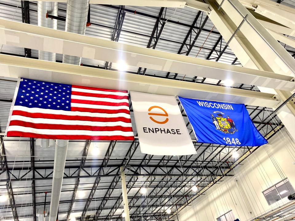 The flags of the United States, Enphase Energy and Wisconsin, hanging in the multipurpose building in Mount Pleasant.