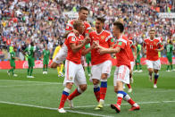 <p>Iury Gazinsky celebrates with his Russian teammates after putting the host nation ahead in the Group A fixture. (Getty) </p>