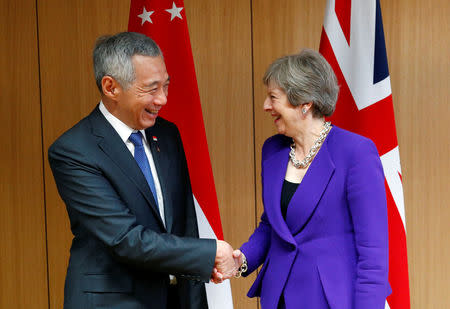 Singapore's Prime Minister Lee Hsien Loong poses with Britain's counterpart Theresa May at the ASEM leaders summit in Brussels, Belgium October 18, 2018. REUTERS/Francois Lenoir/Pool