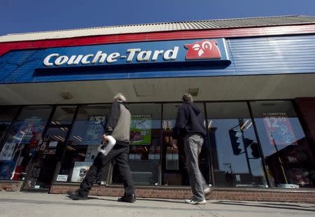 Pedestrians walk past a Couche-Tard convenience store in Montreal, April 18, 2012. REUTERS/Christinne Muschi