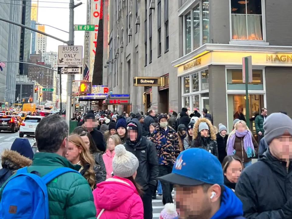 Crowd outside Radio City Music Hall (blurred).