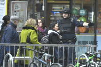 People are guided along the street after a truck crashed into a department store in central Stockholm, Sweden, Friday April 7, 2017. The driver of a hijacked beer truck is wanted by police after the truck crashed into an upscale department store in central Stockholm on Friday, leaving dead and injured in its wake. (Claudio Bresciani/TT via AP)