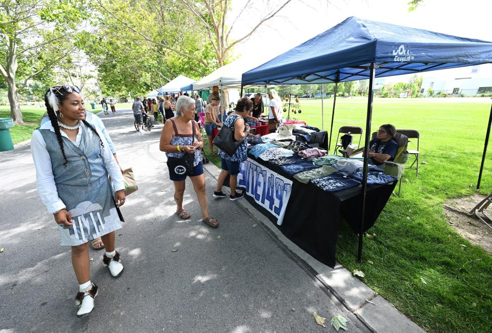 Visitors look at the different crafts for sale at Utah Native Market Days at Thanksgiving Point in Lehi on Friday, Aug. 11, 2023. All proceeds are going to native student scholarships. There was hoop dancing, food and crafts. | Scott G Winterton, Deseret News