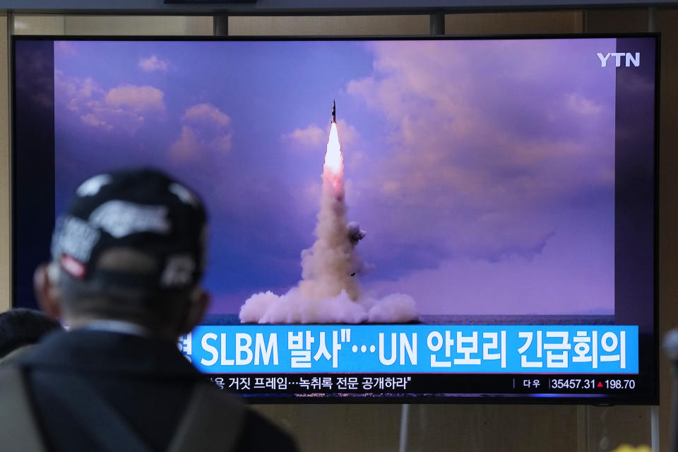 A man watches a TV screen showing an image of North Korea's ballistic missile launched from a submarine during a news program at Seoul Railway Station in Seoul, South Korea, Wednesday, Oct. 20, 2021. North Korea announced Wednesday that it had tested a newly developed missile designed to be launched from a submarine, the first such weapons test in two years and one it says will bolster its military's underwater operational capability. Korean letters read: "North Korea launched a Submarine-Launched Ballistic Missile and U.N. security council emergency meeting." (AP Photo/Ahn Young-joon)