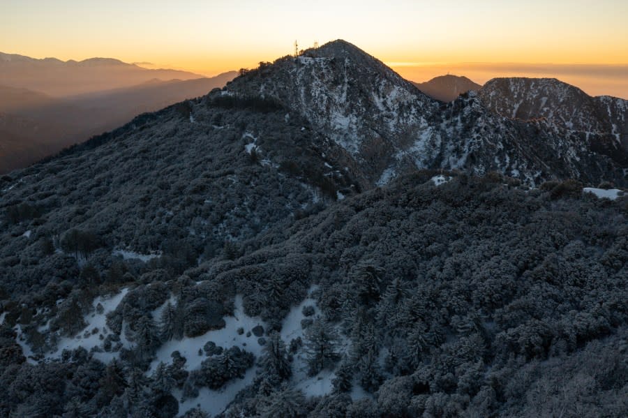 ANGELES NATIONAL FOREST, CA – DECEMBER 13: In an aerial view, cloudless weather at sunrise in the snow-covered San Gabriel Mountains is seen as a massive storm leaves California to spread across the nation on December 13, 2022 in the Angeles National Forest, near Los Angeles, California. The storm system, which brought heavy snow and winds up to 169 miles per hour in the Sierra Nevada Mountains, is predicted to cause blizzards in the northern states, severe weather in the South and a noreaster on the East coast. (Photo by David McNew/Getty Images)