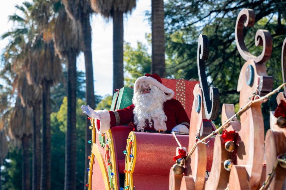 Santa rides in his sleigh pulled by reindeer on top of a Macy’s float at the 40th annual Sacramento Santa Parade on Saturday, Dec. 9, 2023, around Capitol Park.