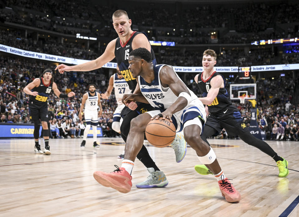 DENVER, CO - MAY 14: Anthony Edwards (5) of the Minnesota Timberwolves drives as Nikola Jokic (15) and Christian Braun (0) of the Denver Nuggets pressure during the second quarter at Ball Arena in Denver on Tuesday, May 14, 2024. (Photo by AAron Ontiveroz/The Denver Post)