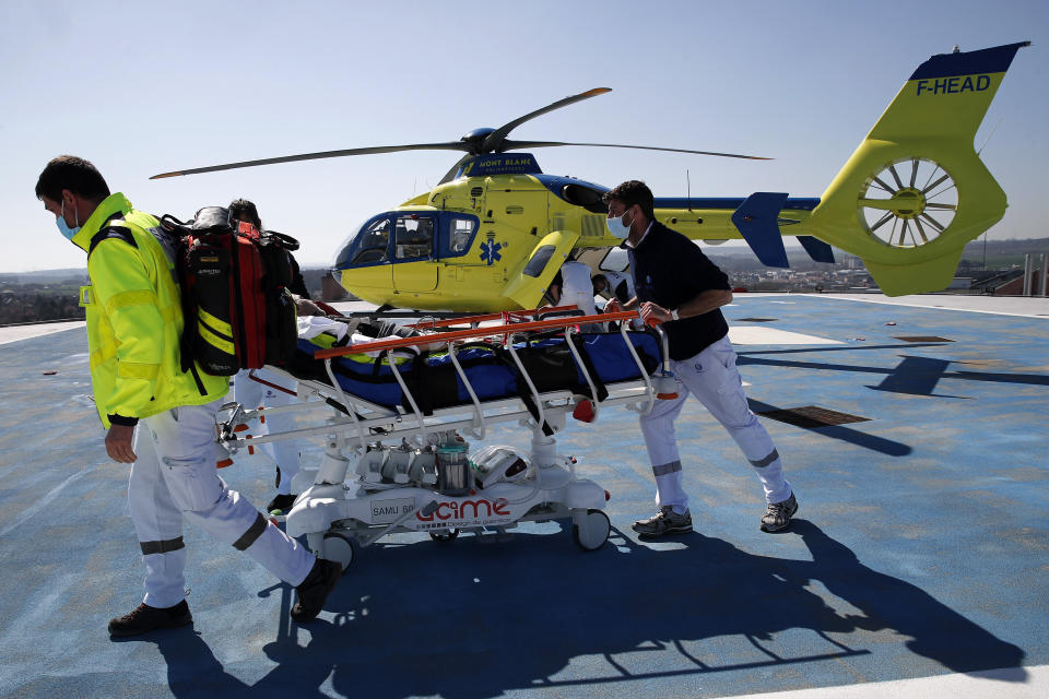 FILE - In this March 30, 2021, file photo, medical workers bring an emergency arrival on the rooftop of the Amiens Picardie hospital in Amiens, north of Paris. European countries scrambled Monday, April 5, to tamp down a surge in COVID-19 cases and ramp up vaccinations, hoping to spare hospitals from becoming overwhelmed by the pandemic’s latest deadly wave of infections. (AP Photo/Francois Mori, File)