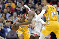 Los Angeles Lakers guard Avery Bradley (11) reaches in as Houston Rockets guard James Harden, middle, drives to the basket as Lakers guard Danny Green (14) watches during the first half of an NBA basketball game Saturday, Jan. 18, 2020, in Houston. (AP Photo/Michael Wyke)