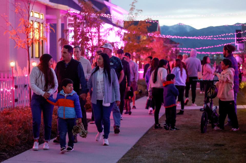 People walk through a Daybreak neighborhood that is decorated in a “Barbie” theme for Halloween in South Jordan on Friday, Oct. 13, 2023. | Kristin Murphy, Deseret News