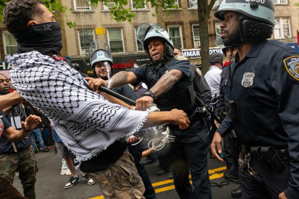 A protester and police scuffle at the demonstration. Getty Images