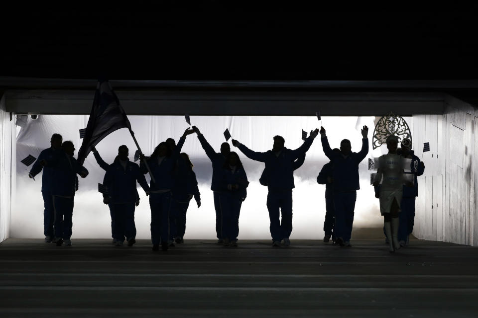 Athletes from Greece are silhouetted as they arrive during the opening ceremony of the 2014 Winter Olympics in Sochi, Russia, Friday, Feb. 7, 2014. (AP Photo/Mark Humphrey)