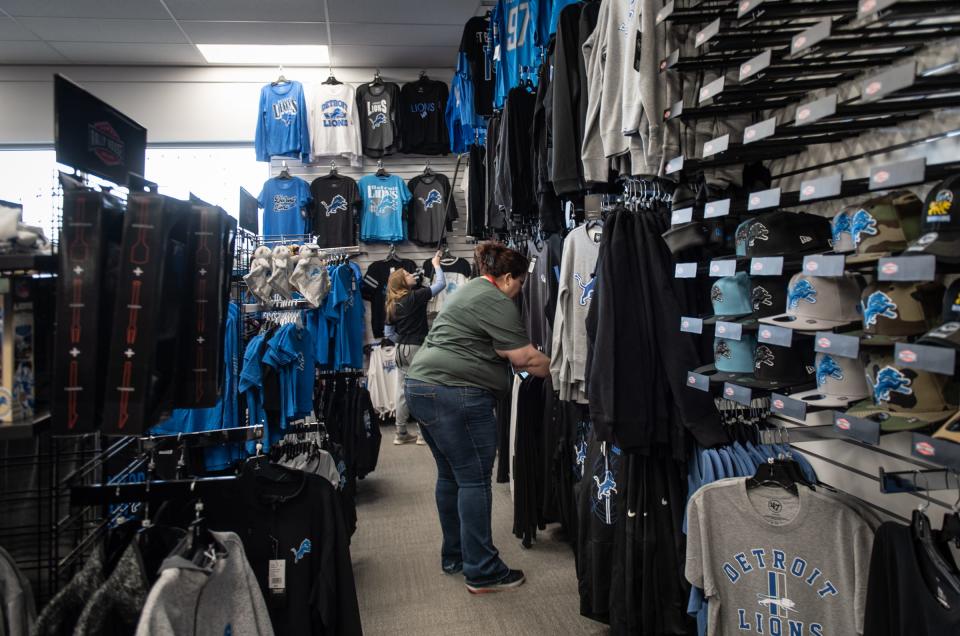 Rally House East Lansing employees restock Detroit Lions merchandise at their store, Monday, Jan. 22, 2024. Store Manager Dawn LaChane says sales of Lions merchandise have been up about 80% the past couple of weeks.