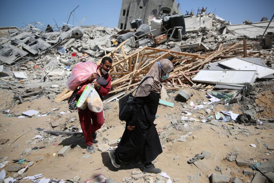 Two Palestinians walk amid rubble left by the Israeli assault on Shifa Hospital in northern Gaza (AFP via Getty Images)