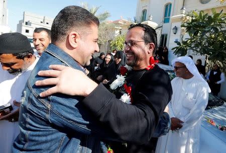 Ali Al-Ekri (R) hugs his family member as he is welcomed home after completing his five-year sentence, in Manama, Bahrain March 10, 2017. REUTERS/Hamad I Mohammed