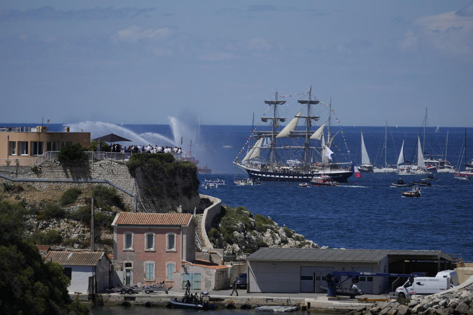 The Belem, the three-masted sailing ship which is carrying the Olympic flame, is accompanied by other boats approaching Marseille, southern France, Wednesday, May 8, 2024. After leaving Marseille, a vast relay route is undertaken before the torch odyssey ends on July 27 in Paris. The Paris 2024 Olympic Games will run from July 26 to Aug.11, 2024. (AP Photo/Thibault Camus)