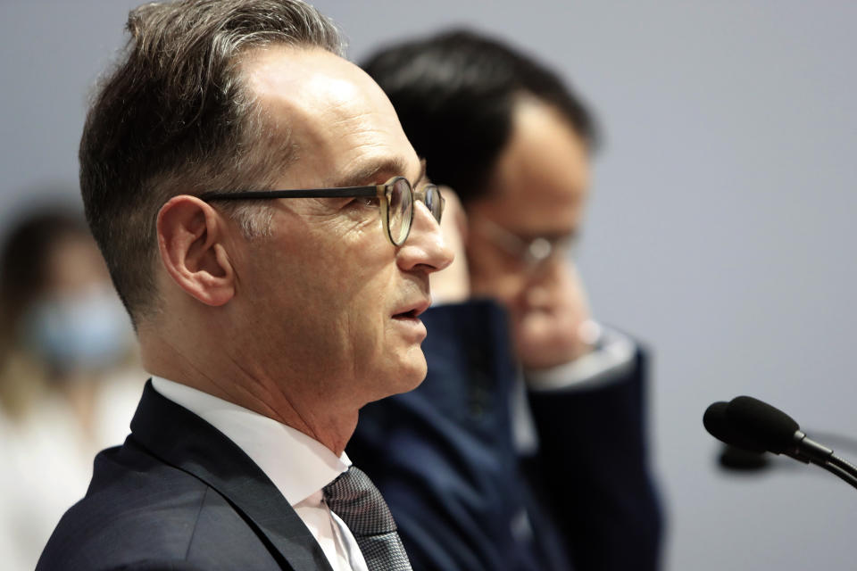 German Foreign Minister Heiko Maas, left, and his Cyprus' counterpart Nicos Christodoulides talk to the media during a press conference at the foreign ministry house in divided Nicosia, Cyprus, Tuesday, Oct. 13, 2020. Maas is in Cyprus for a one-day visit. (AP Photo/Petros Karadjias)