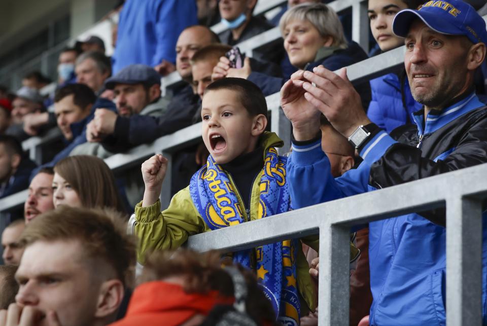 Soccer fans react during the Belarusian Cup final soccer match between BATE Borisov and Dynamo Brest in Minsk, Belarus, Sunday, May 24, 2020. BATE Borisov has won the Belarusian Cup with thousands of fans watching in a rare case of a soccer trophy being decided during the coronavirus pandemic. Belarus has not stopped holding public gatherings with spectators. (AP Photo/Sergei Grits)