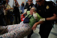 <p>People are removed from a sit-in outside of Senate Majority Leader Mitch McConnell’s office as they protest proposed cuts to Medicaid, Thursday, June 22, 2017 on Capitol Hill in Washington. (Photo: Jacquelyn Martin/AP) </p>