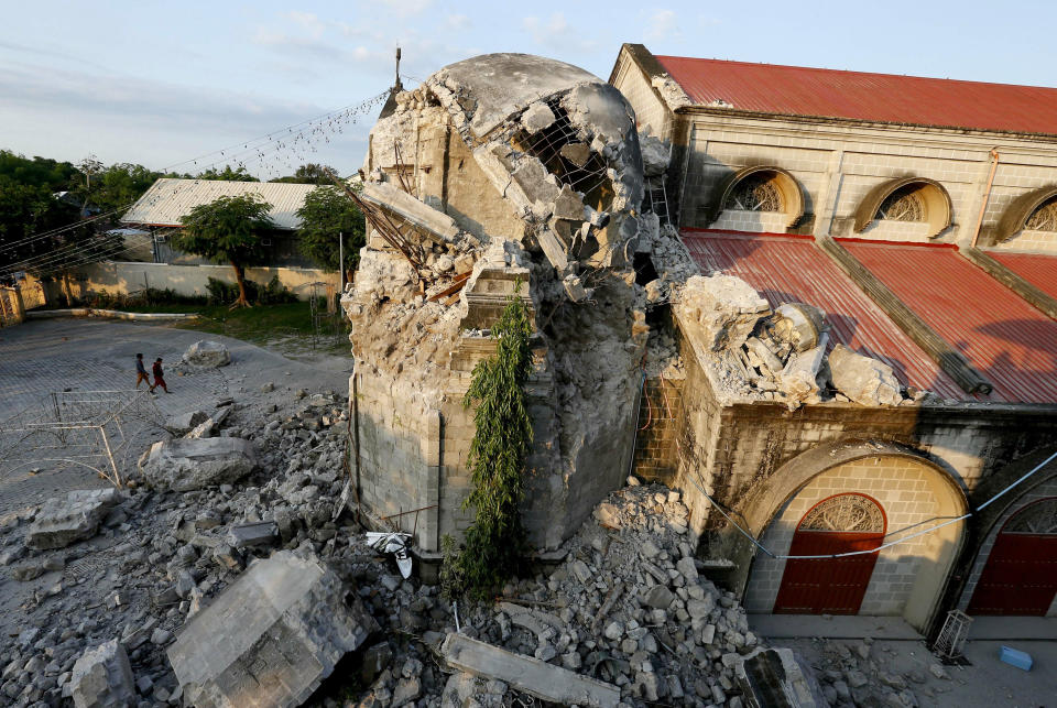 The damage of St. Catherine church following a 6.1 magnitude earthquake that also caused the collapse of a commercial building, is seen in Porac township, Pampanga province, north of Manila, Philippines, Tuesday, April 23, 2019. The strong earthquake struck the northern Philippines Monday trapping some people in a collapsed building, damaged an airport terminal and knocked out power in at least one province, officials said. (AP Photo/Bullit Marquez)